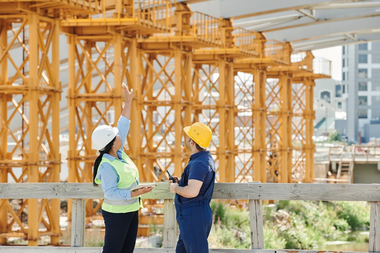 creative-02 A Man and a Woman with Ppe's Talking at a Construction Site